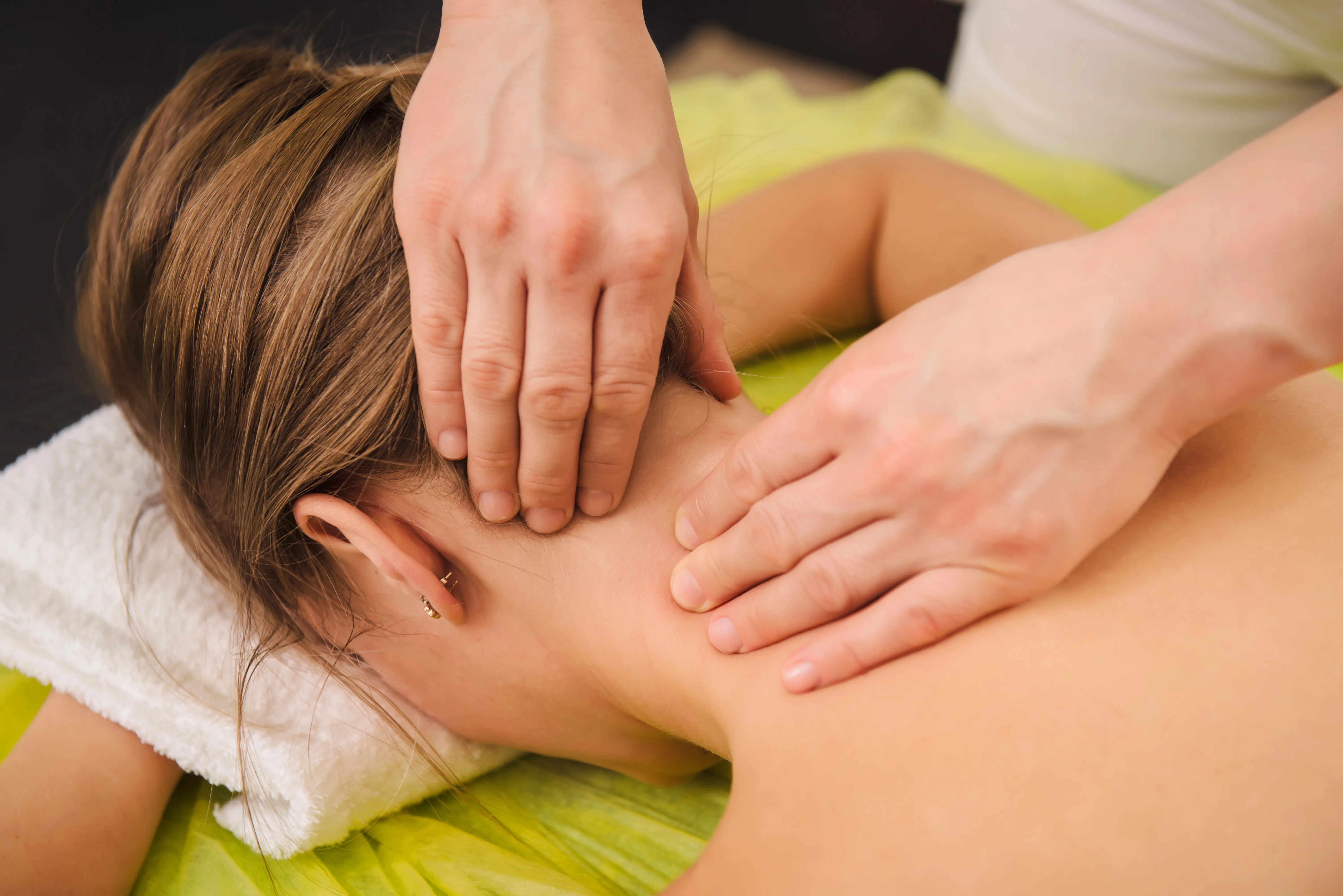 Classical neck and shoulder massage. Beautiful woman enjoying a treatment in a spa center. Body and