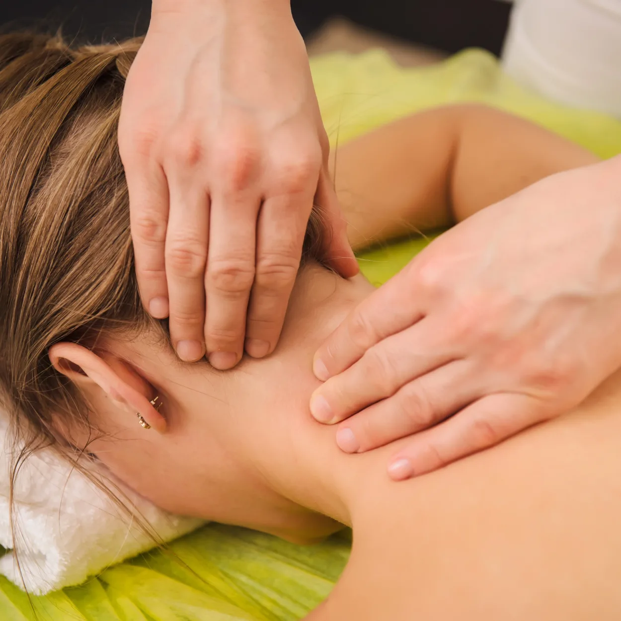 Classical neck and shoulder massage. Beautiful woman enjoying a treatment in a spa center. Body and
