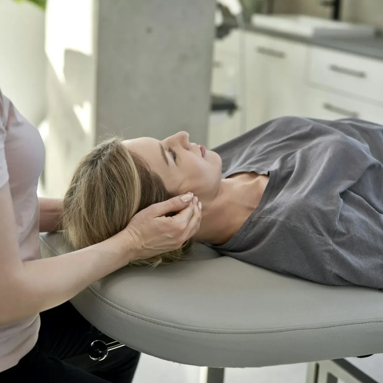 Female physical therapist massaging her patient