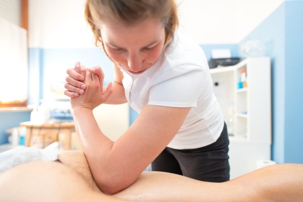 Physiotherapist performs deep and de-contracting drainage