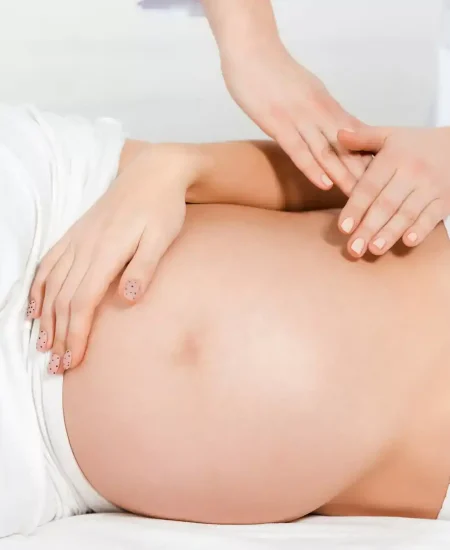 cropped-view-of-masseur-doing-massage-of-belly-to-pregnant-girl-on-massage-table-jpg.webp